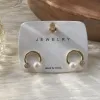 This is a simple, fashionable and elegant women's ear accessory with golden circular stud earrings and pearl zircon decoration details Picture